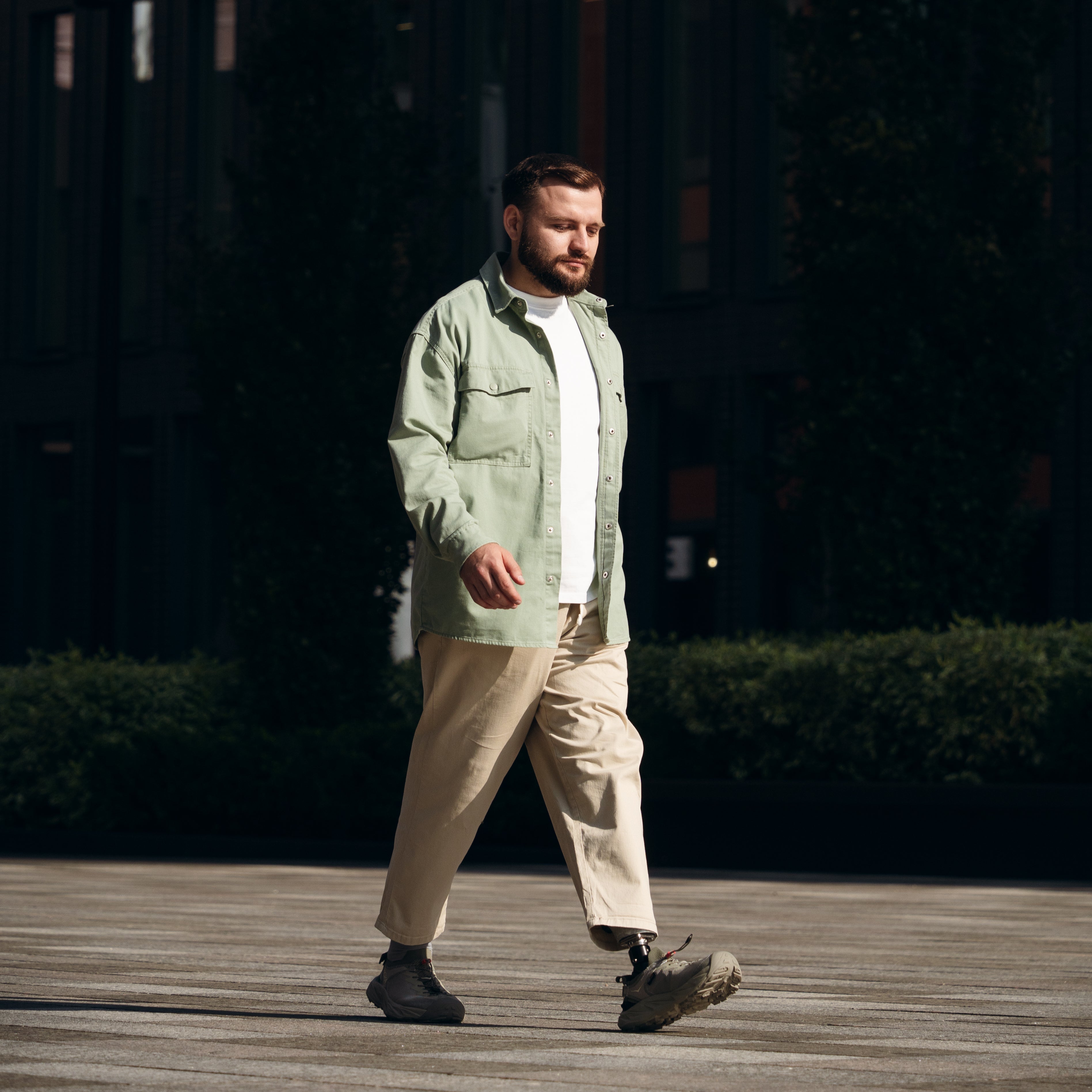 Man walking with a prosthetic foot with a dark background